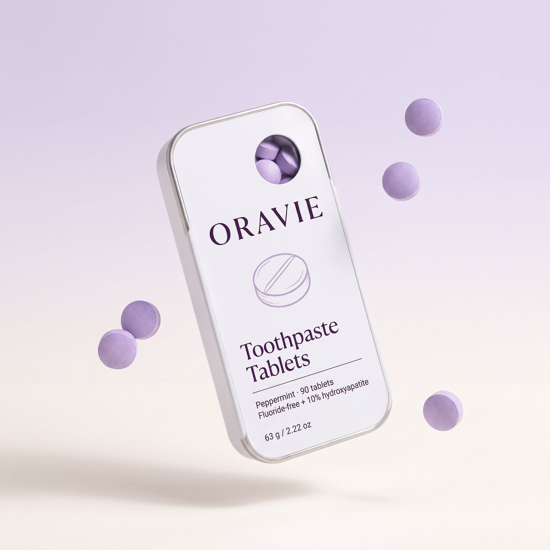 ORAVIE Toothpaste Tablets tin floating with lavender tablets on a soft lavender background