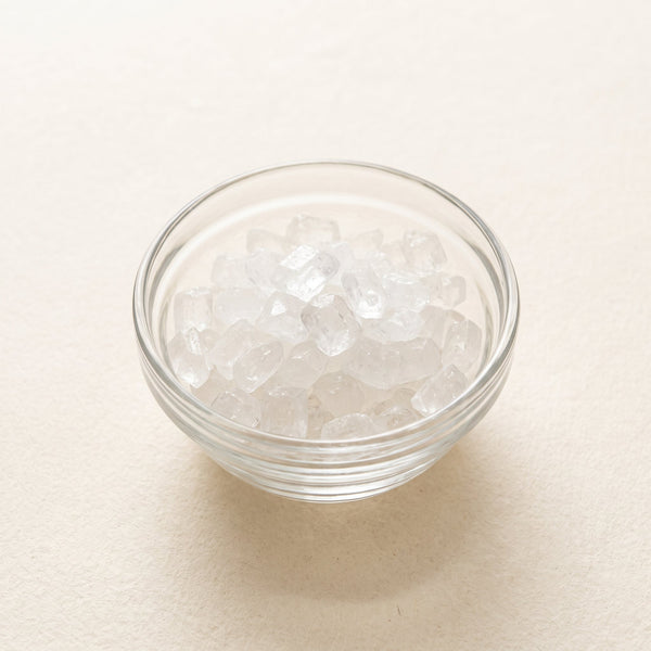 Clear sugar-like xylitol crystals in a glass dish