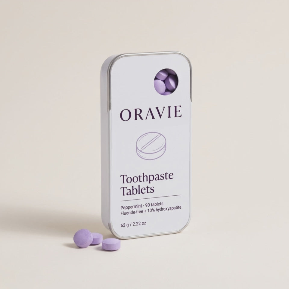 Hero video: a hand slides open the ORAVIE tin and takes out one lavender toothpaste tablet